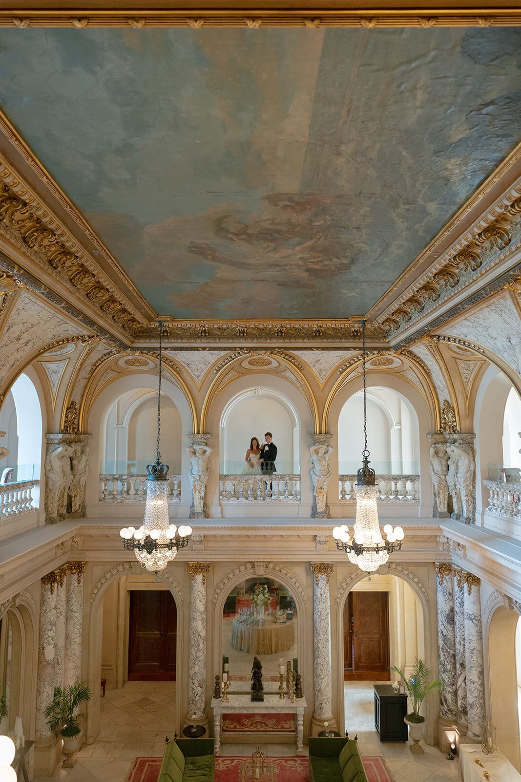 Kaitlyn and Chris on a balcony beneath the painted ceiling of the great hall at Elkins Estate